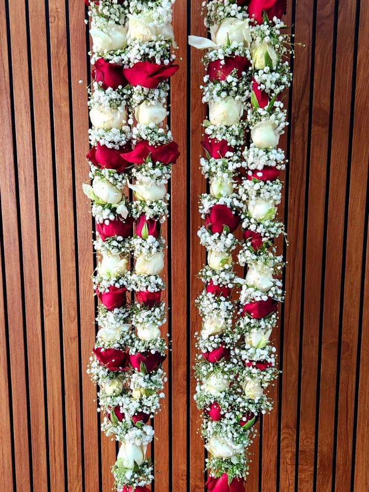 Traditional garland arrangement by Flower Story